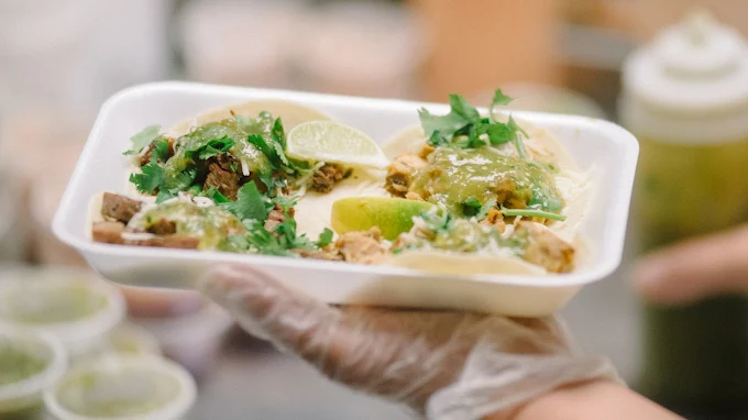 Tray of fresh street tacos with salsa verde and lime